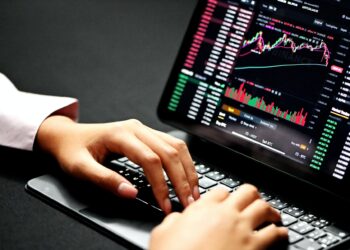 Executive woman trading on her laptop