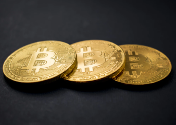 Golden bitcoin over black table