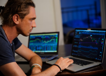 Man using his laptop to trading stocks
