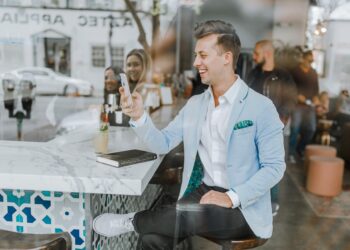 Smalling man using his smartphone