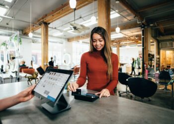 Woman using her card to make a digital payment