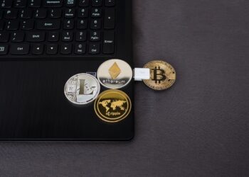 Crypto coins on black laptop