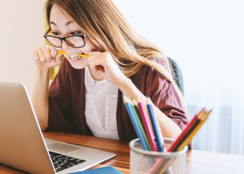 Woman biting pencil