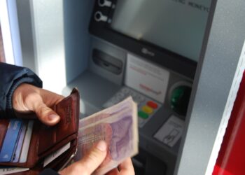 Person withdrawing money from UK ATM