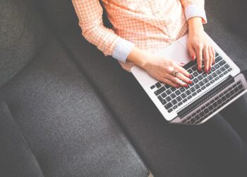 Woman writing in her Laptop