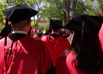 Graduating students stand during Harvard University's 371st Commencement Exercises in Cambridge, Massachusetts, U.S., May 26, 2022. | FintechZoom