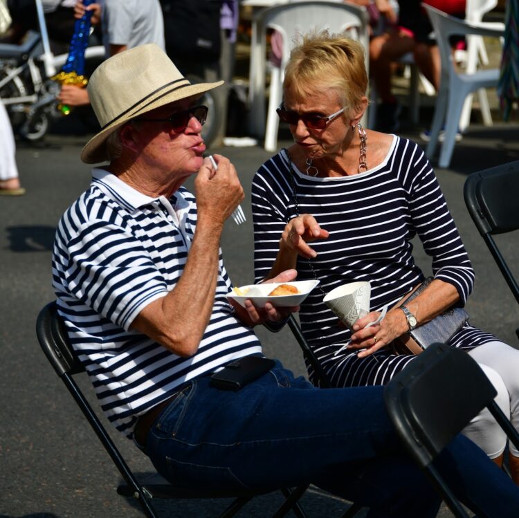 Older couple sitting in restaurant | FintechZoom