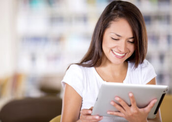 Woman reading eBook | FintechZoom