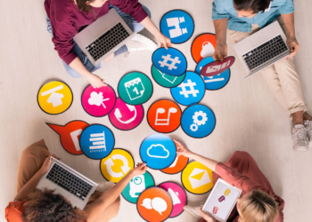 Persons with laptop and selection social media logos | FintechZoom