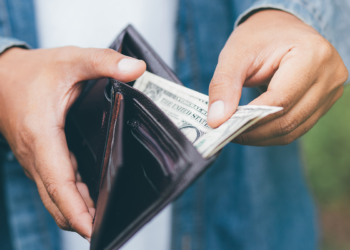 US Consumer check his money on wallet | FintechZoom