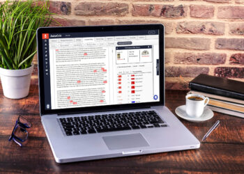 Laptop on desk with a word processor text | FintechZoom