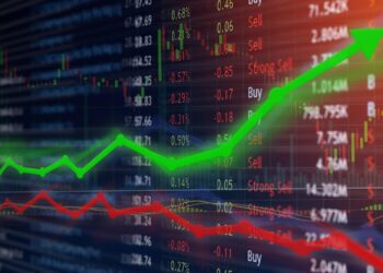 Green up arrow over stock market dashboard | FintechZoom