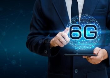 Man holding a tablet and over it a digital world with 6g symbol | FintechZoom