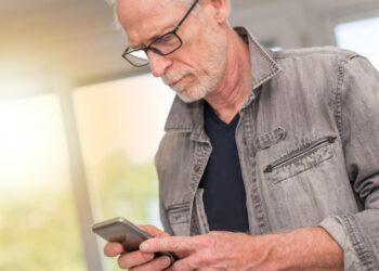Man using Smartphone | FintechZoom