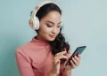 Indian Girl Listen Music in her mobile - FintechZoom