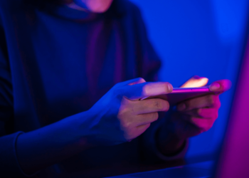 Person using his mobile to play - FintechZoom