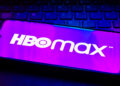 Mobile with HBO Max App over black Keyboard | FintechZoom