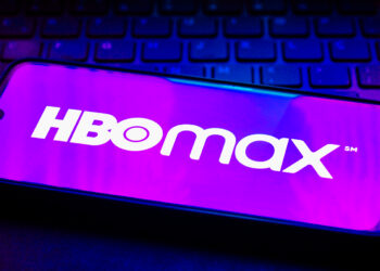 Mobile with HBO Max App over black Keyboard | FintechZoom