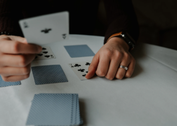 Person Playing Solitaire - FintechZoom