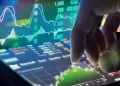 Person using hand on tablet analyzing stocks charts | FintechZoom