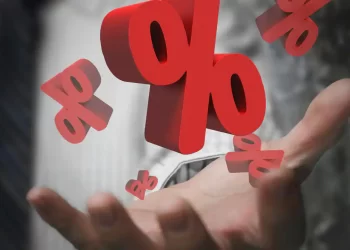 Percentage Symbols on Person's hand | FintechZoom