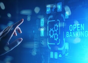 Person holding the hand near blue digital screen with open banking logo | FintechZoom