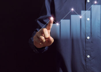 A person showing a business growth bar graph | FintechZoom