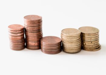 Coins on White Table | FintechZoom