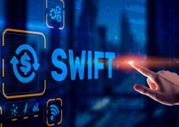 Person pointing the finger to a digital blue screen with Swift word | FintechZoom