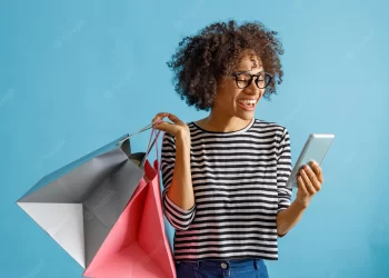woman using phone on shopping | FintechZoom