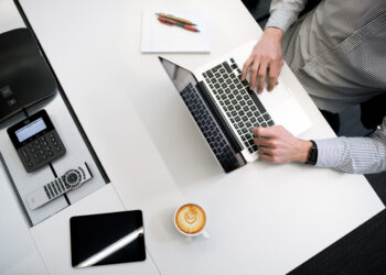 Person using Laptop | FintechZoom