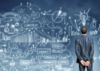 Man looking for a board with several charts | FintechZoom
