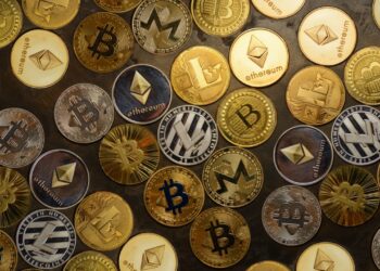Several altcoins on black table | FintechZoom