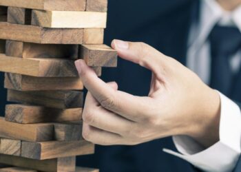 Business Man took a piece from woos tower game | Fintechzoom