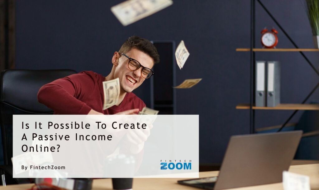 A man smiles as he sits at a desk, throwing cash into the air. A laptop and coffee cup are also on the desk. The caption reads, "Is It Possible To Create A Passive Income Online?" by FintechZoom. | FintechZoom