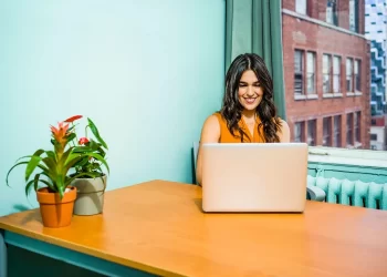 Woman using laptop | FintechZoom
