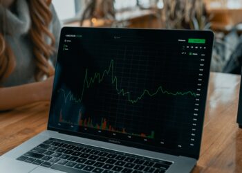 MacBook Pro with Stock Chart on Screen | FintechZoom