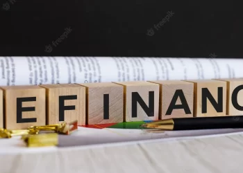 Word refinance is written wooden cubes near pen document | FintechZoom