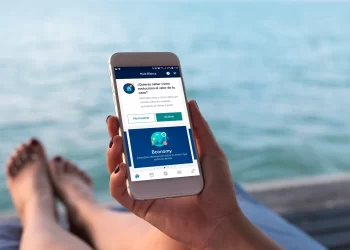 Person using Banking App near pool | FintechZoom
