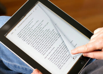 Person reading an Ebook | FintechZoom