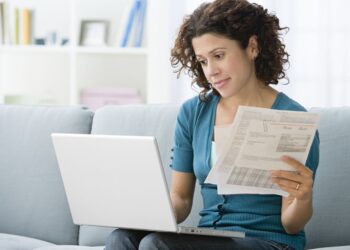 Woman Paying Bills Online | FintechZoom