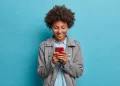Young Girl using Smartphone | FintechZoom