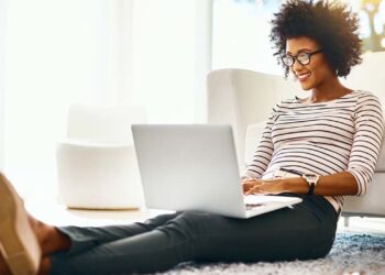 Woman at laptop | FintechZoom