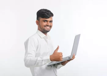 Indian man using laptop | FintechZoom