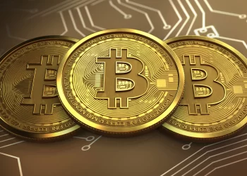 Golden Bitcoin over chip | FintechZoom