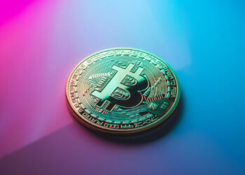 Bitcoin over a purple background | FintechZoom