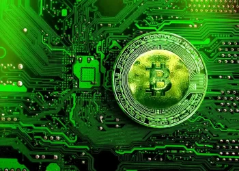 Green bitcoin on processor | FintechZoom