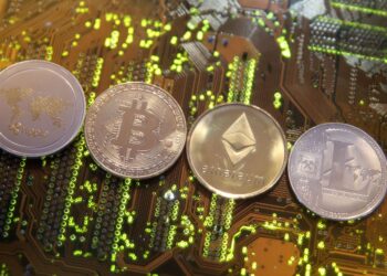 Ripple, Bitcoin, Etherum and Litecoin virtual currencies are seen on a PC motherboard | FintechZoom