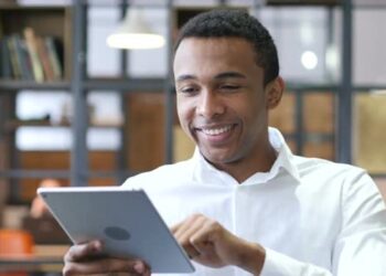 Person on Tablet | FintechZoom
