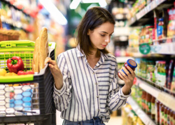 Person looking to the bill in supermarket | FintechZoom